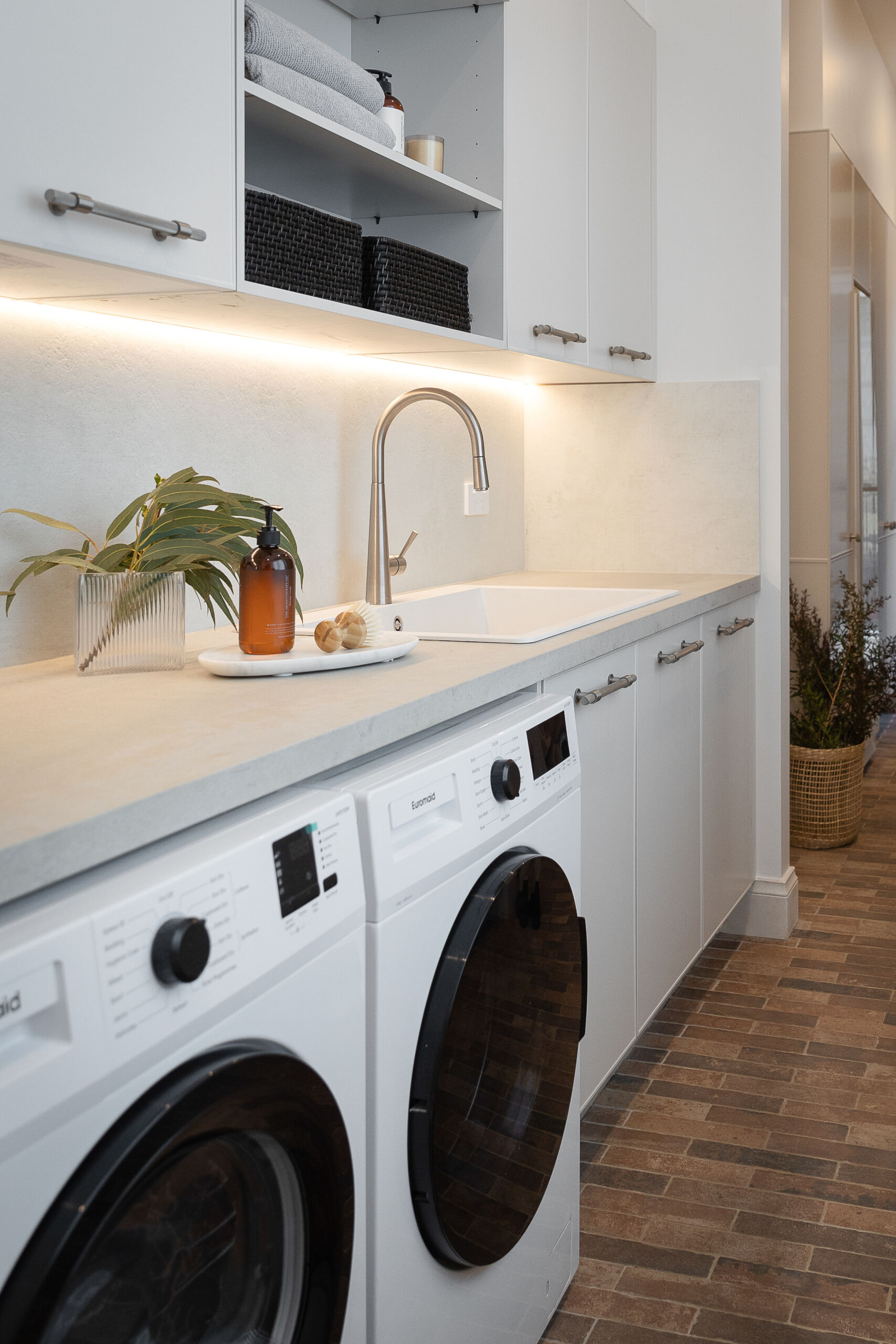 he Block 2022 Rachel and Ryan balance style and substance in their glamorous laundry room design. Fitted with a side by side washer and dryer combination and generous Ceasartone Primordia benchtop it provides ample storage space for work areas and easy organisation.