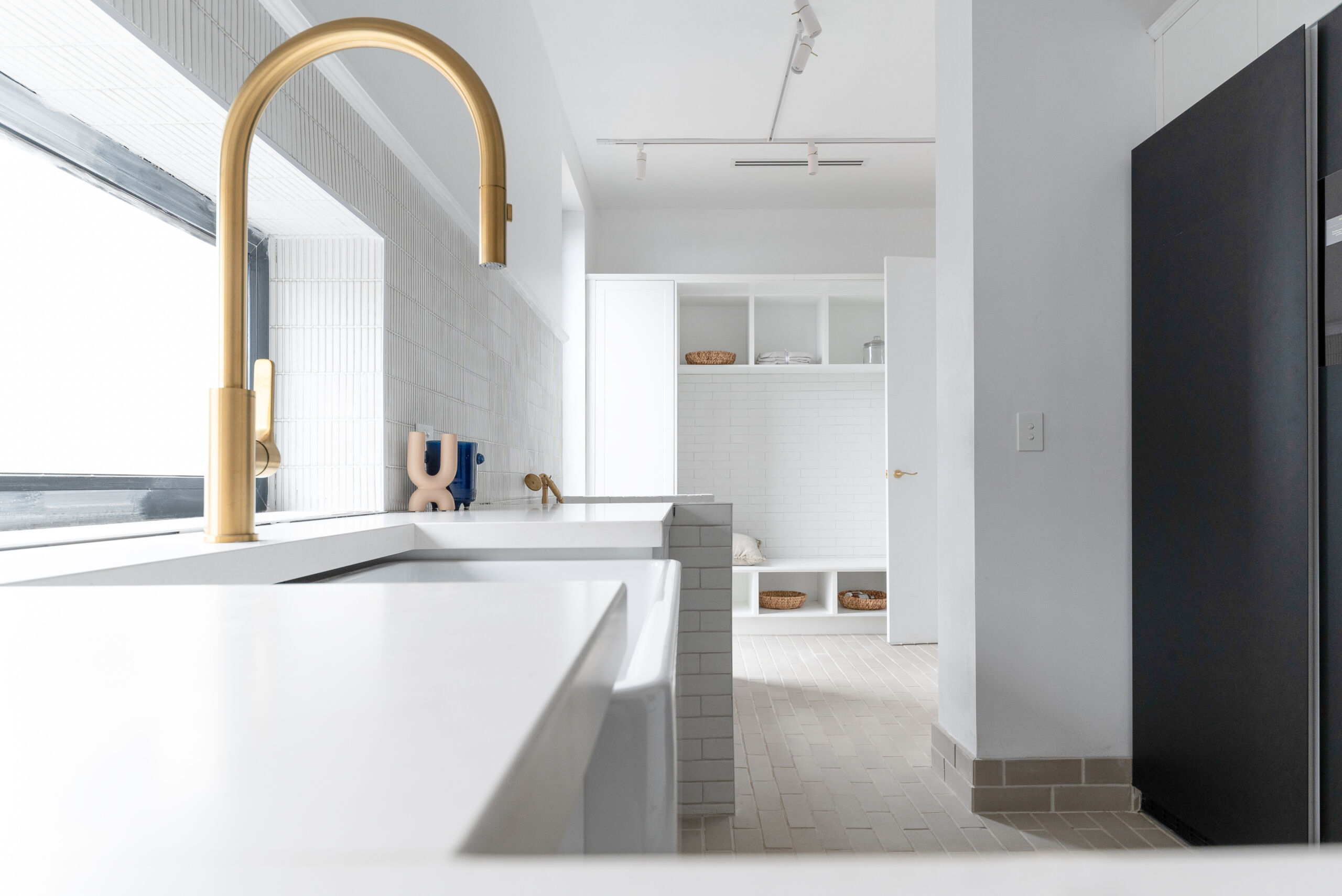 The Block 2022 Omar and Oz's U-shaped Laundry room layout features shaker-style Sierra joinery in Matt White, handleless Touch Catch doors and Caesarstone® Riverlet benches.