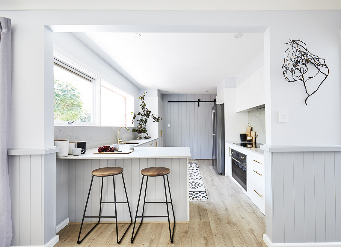 Modern white and grey kitchen with U-shaped island bench