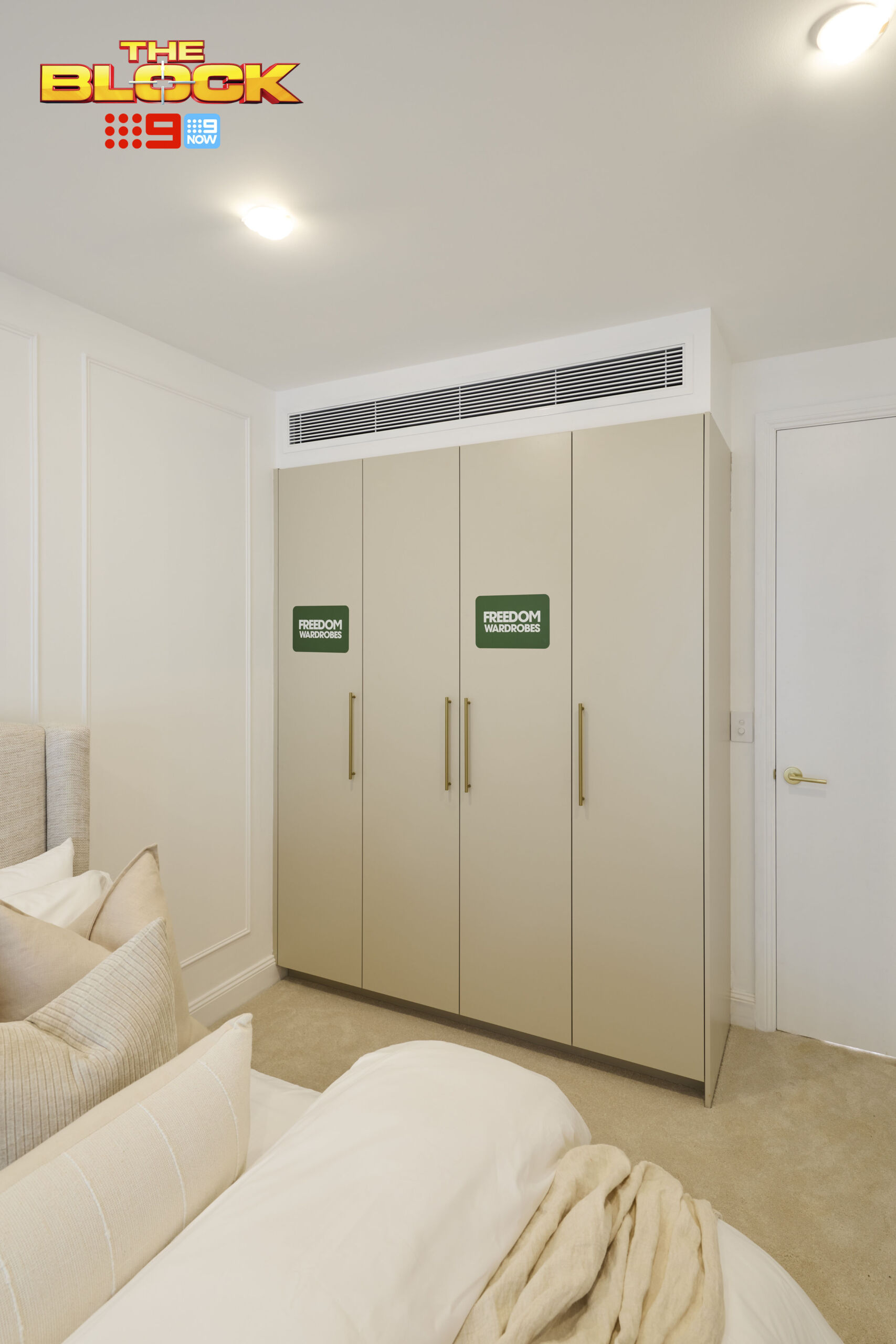 Modern Greige wardrobe doors paired with Brushed Satin Brass handles create a stylish builtin wardrobe.