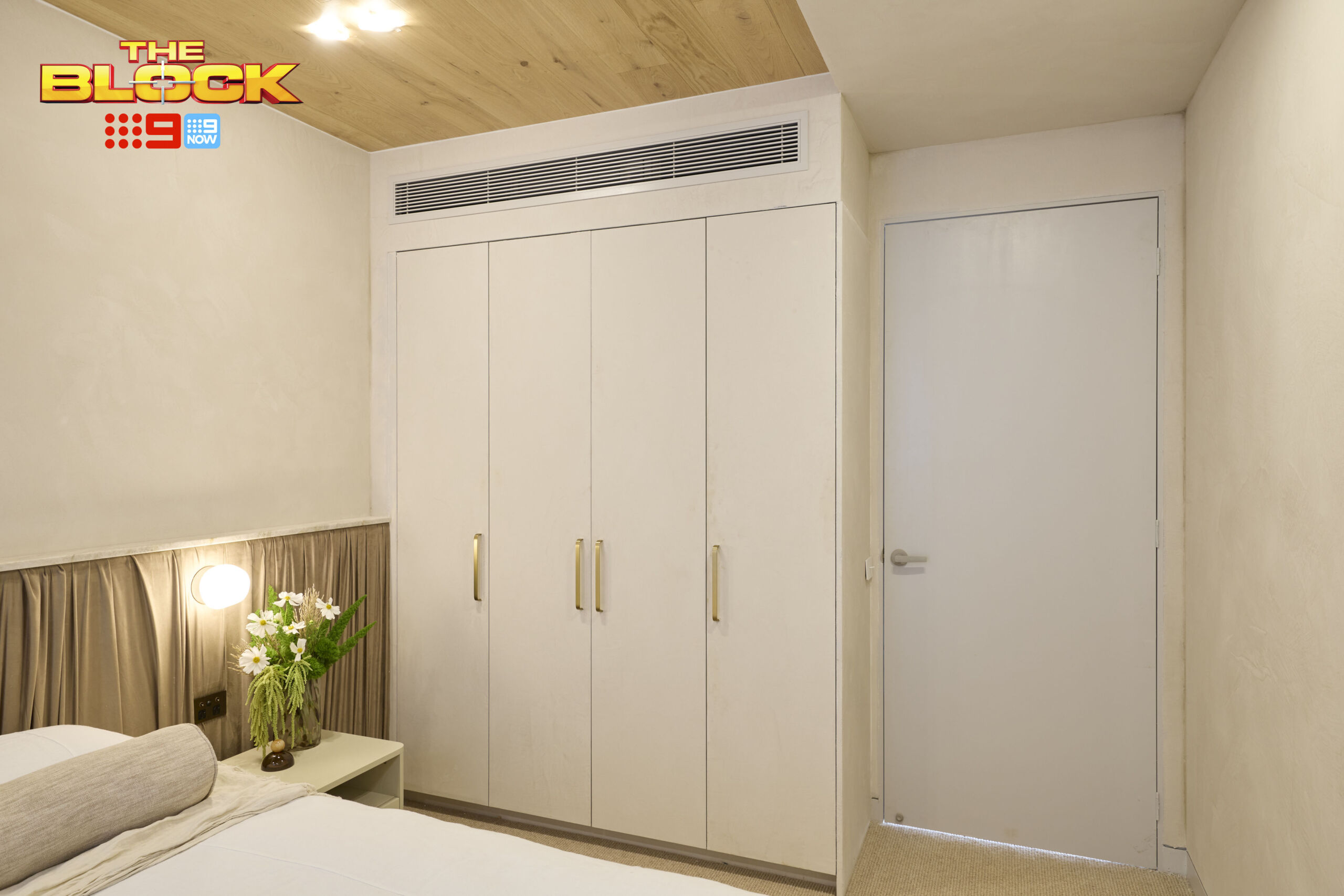 Built-in wardrobe with a neutral colour palette and timber-look finish, complementing the contemporary bedroom interior.