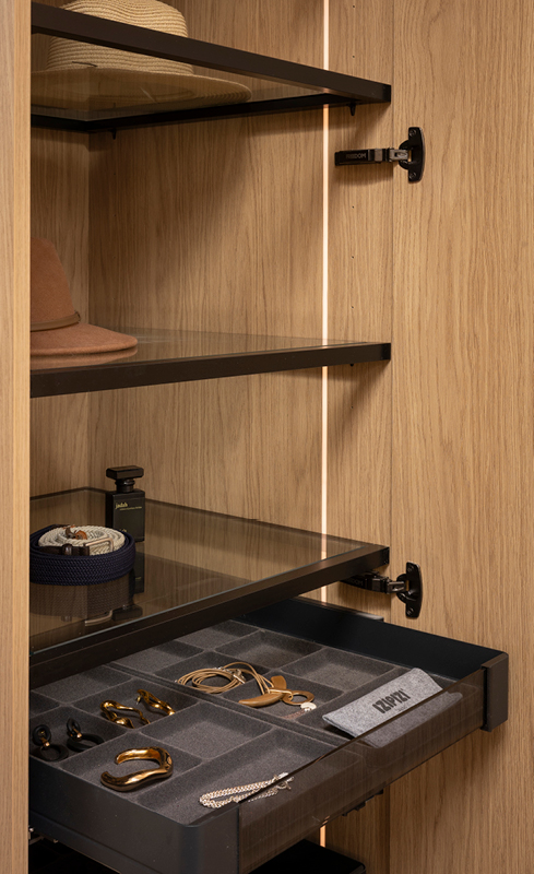 Open jewellery drawer with glass shelving and integrated wardrobe lighting