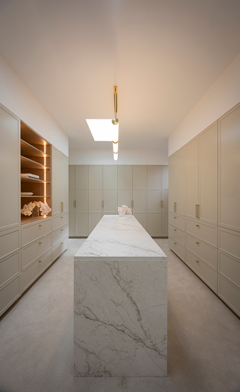 Chantel and Wyatt’s greige walk-in wardrobe with illuminated Nordic Oak shelving
