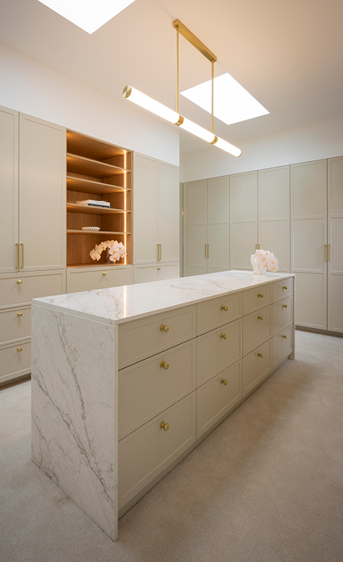 Chantel and Wyatt’s walk-in wardrobe with greige cabinetry and marble-look island