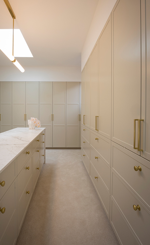 Greige shaker wardrobe cabinetry and central storage island in House 2