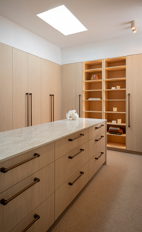 Pale Oak wardrobe cabinetry, bronze handles and Cosentino stone island in House 3