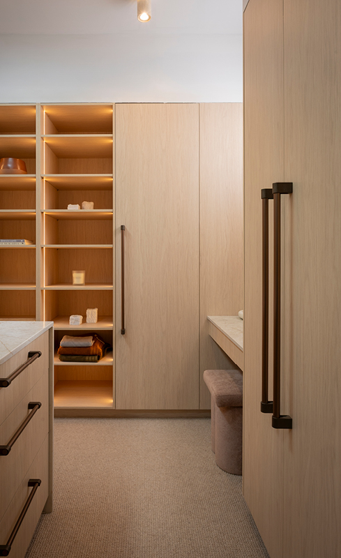 Integrated wardrobe shelving and dressing table inside Lisa and Rosco’s walk-in wardrobe