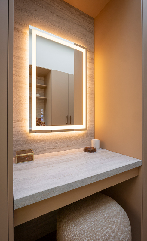 Dedicated wardrobe makeup table with stone benchtop and illuminated Bluetooth mirror