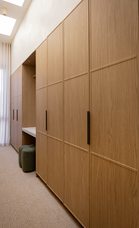 Textured Nordic Oak wardrobe doors beneath a skylight in House 5