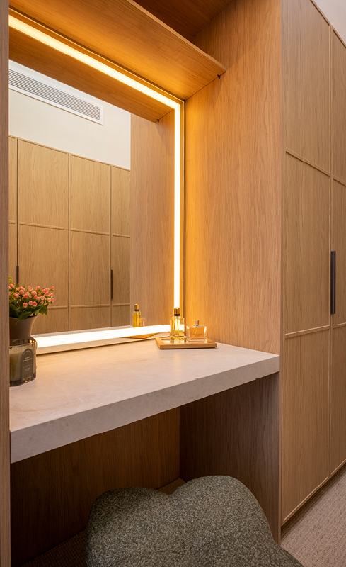 Integrated lighting around the mirror in Rick and Tayla’s wardrobe makeup zone