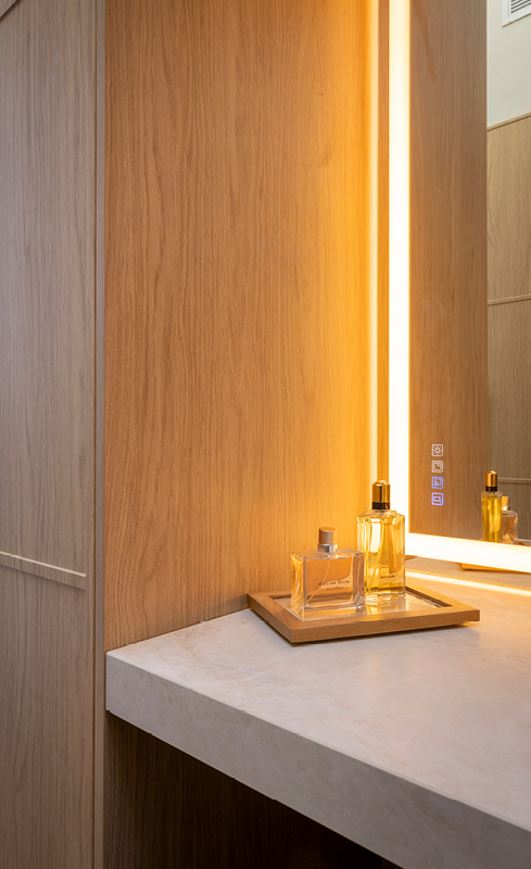 Warm LED lighting detail within Nordic Oak wardrobe cabinetry