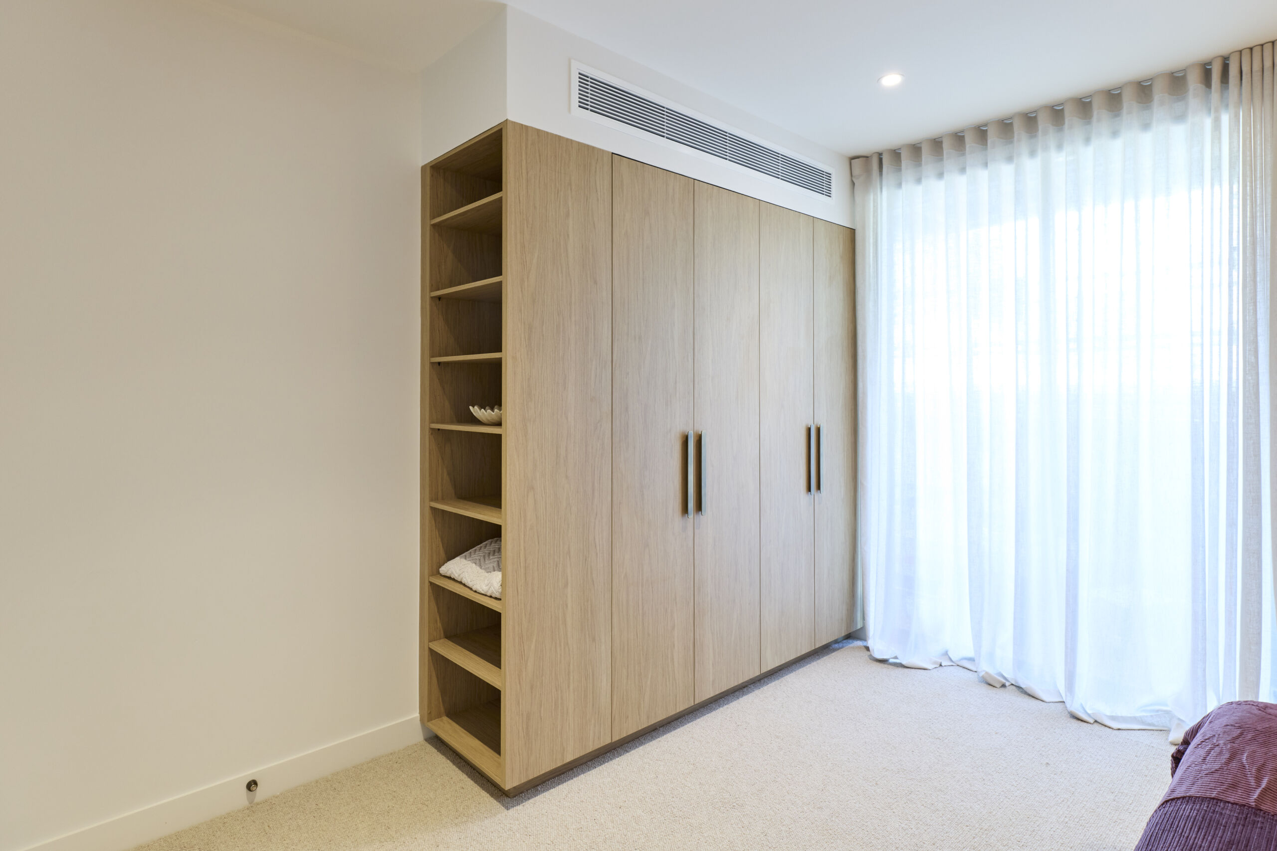H1 RM6 GUEST SUITE BEDROOM & ENSUITE Adam and Jolene-052 Timber look built in wardrobe with open shelving on one side.