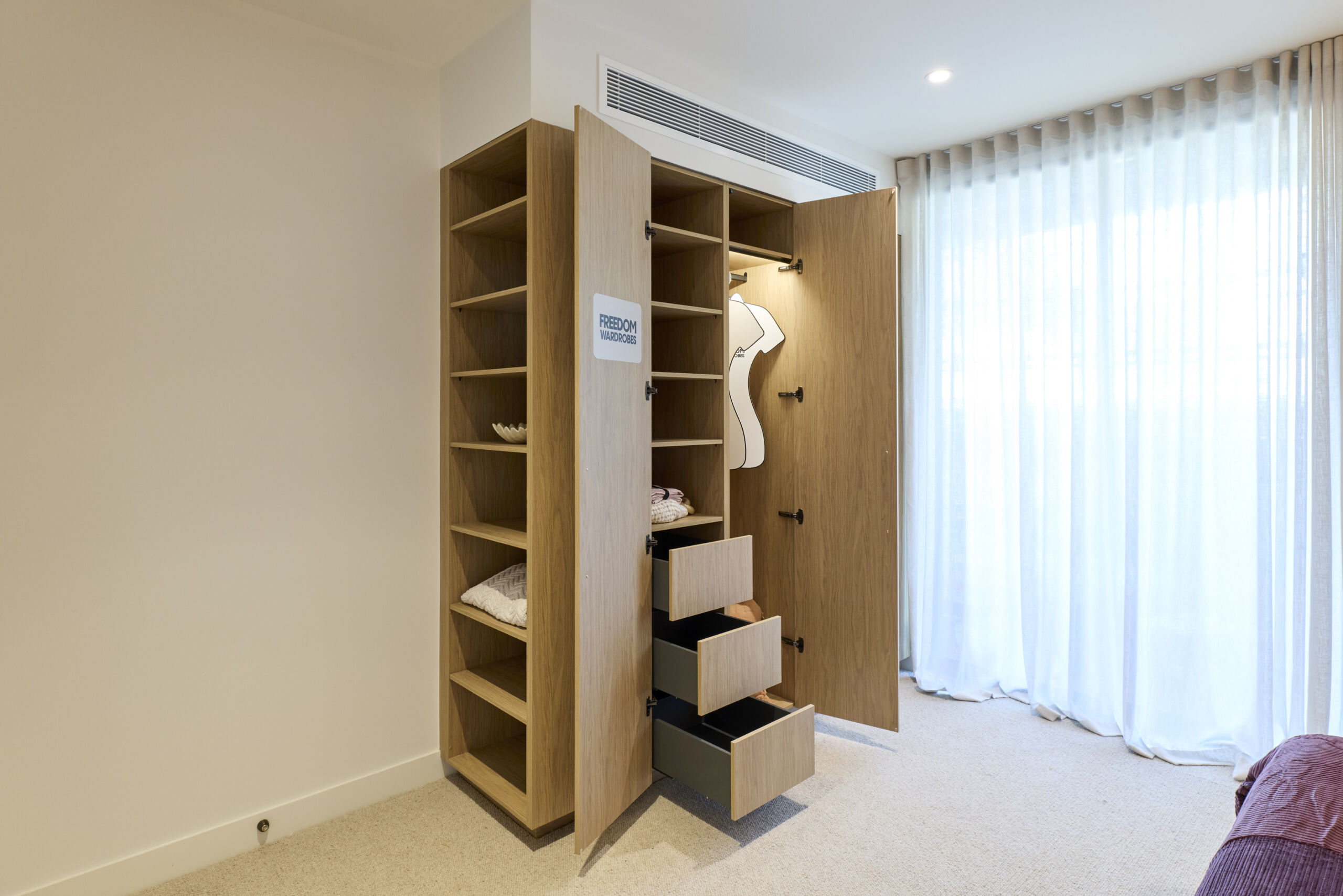 H1 RM6 GUEST SUITE BEDROOM & ENSUITE Adam and Jolene-053 (1) Open wardrobe showing drawers and hanging space