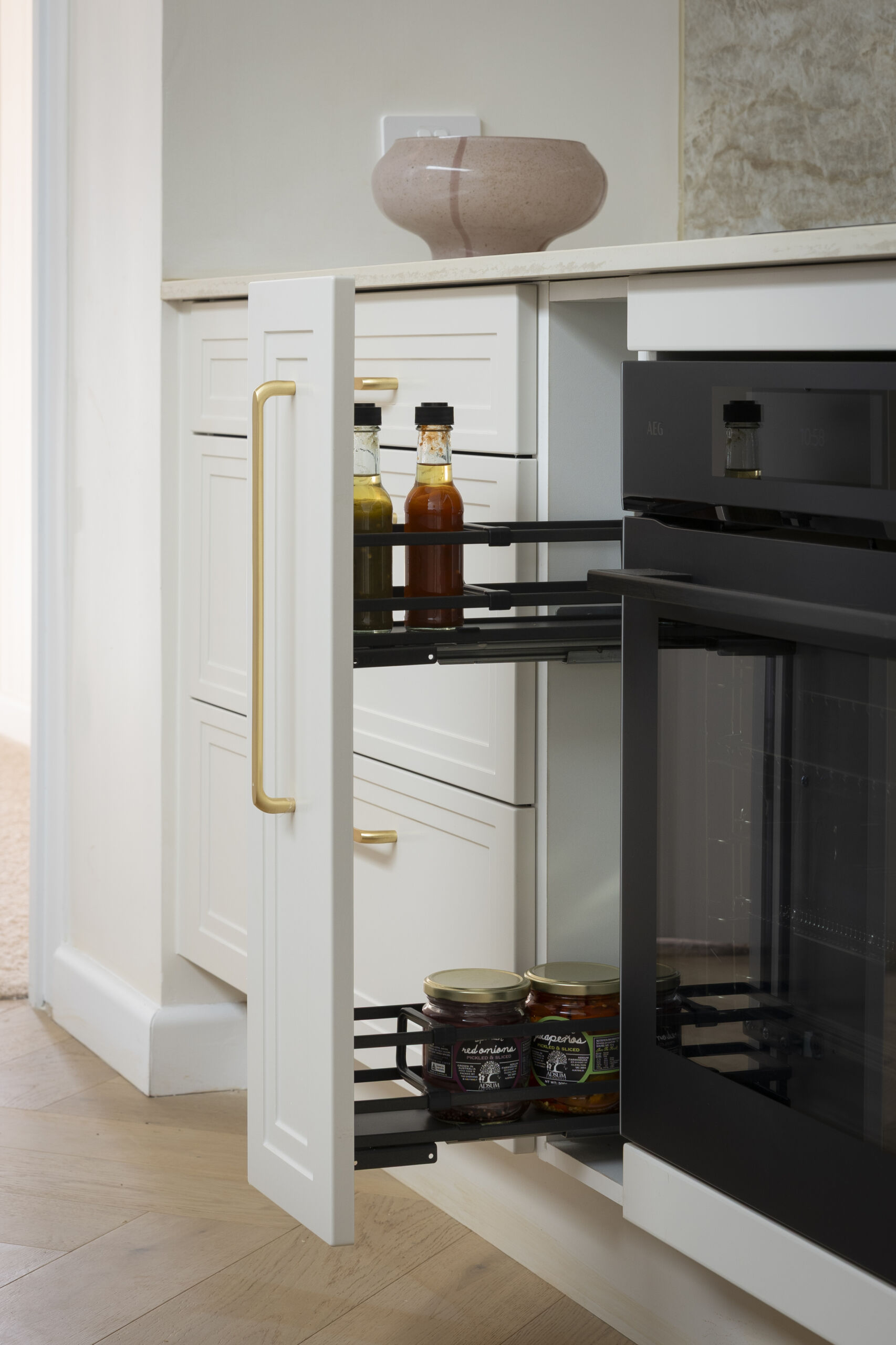 H2 HAN & CAN Kitchen MA147 Small pull out pantry next to oven with storage for cooking essentials