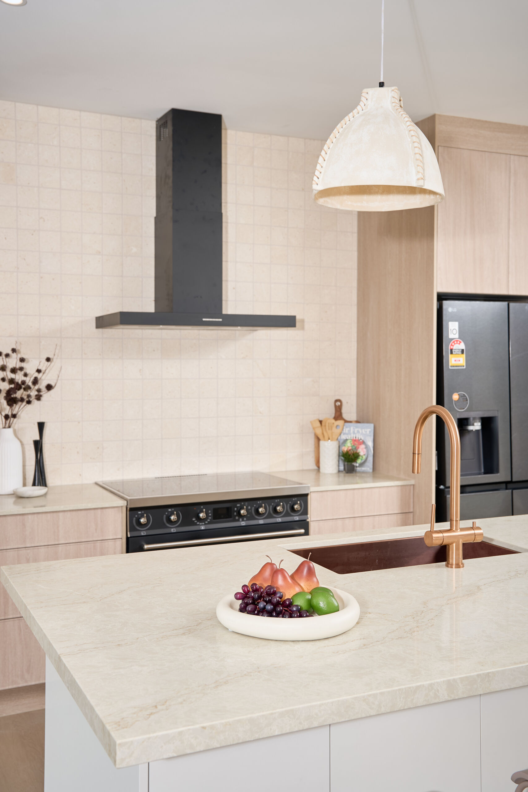 Brisbane Photographer light timber kitchen with marble look kitchen island and copper look sink and tap