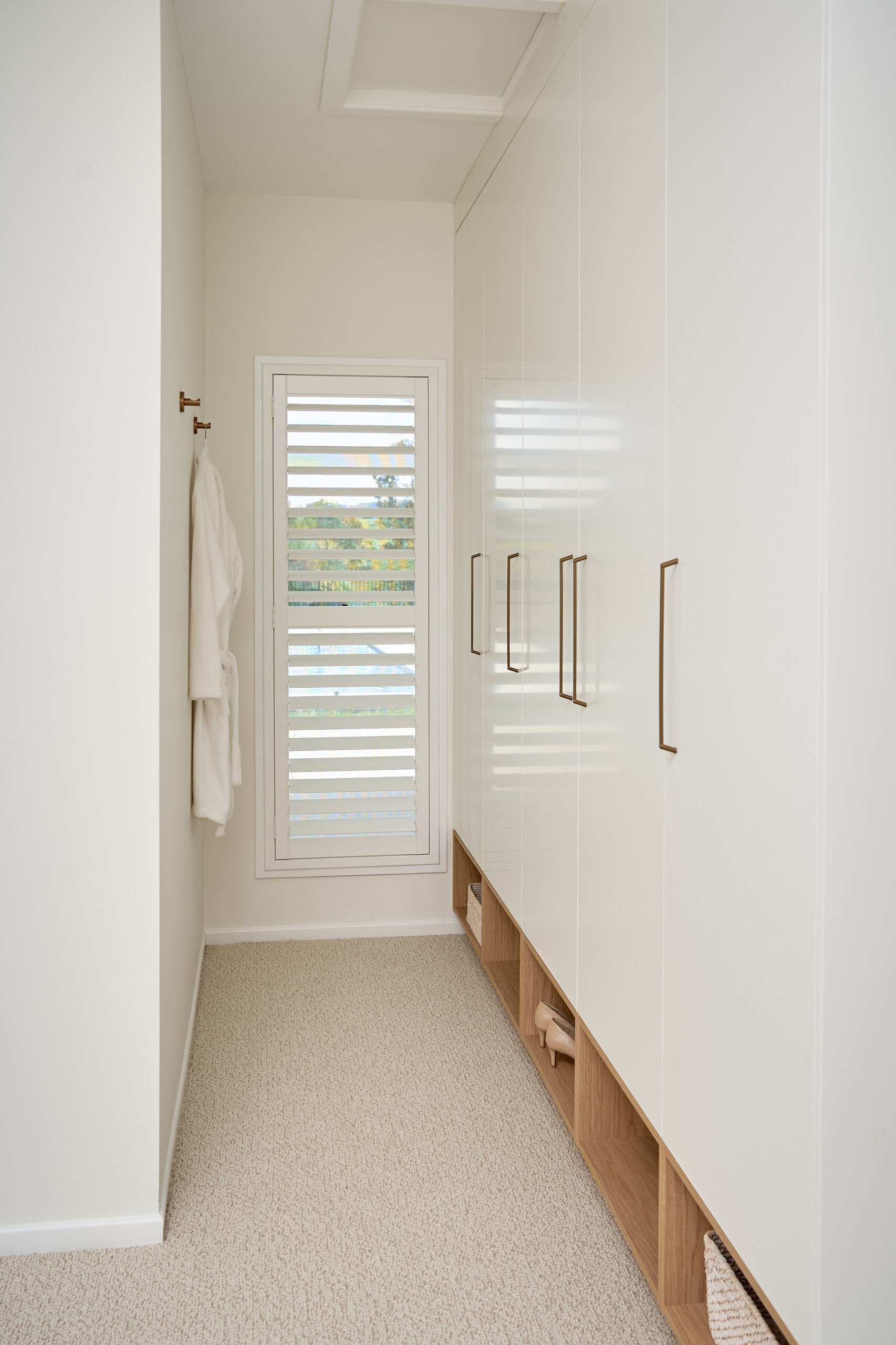 Brisbane Photographer White built in wardrobe with bronze handles and timber-look details
