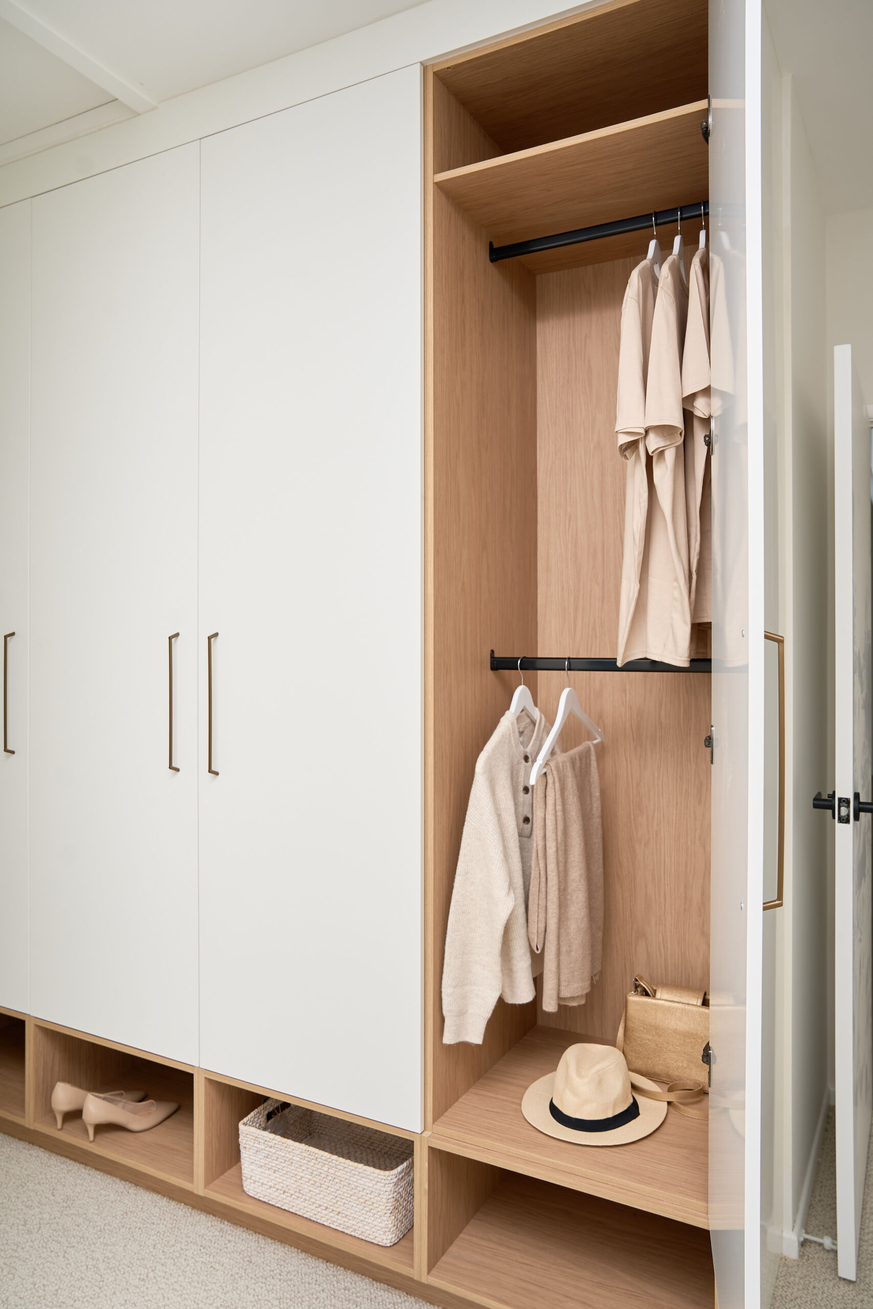 Brisbane Photographer Close up image of an open wardrobe with timber-look internals and plenty of storage